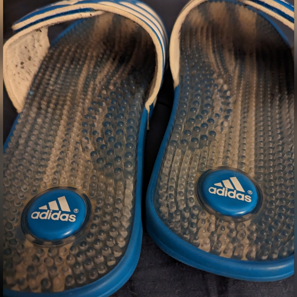 Well worn women's blue Adidas slides